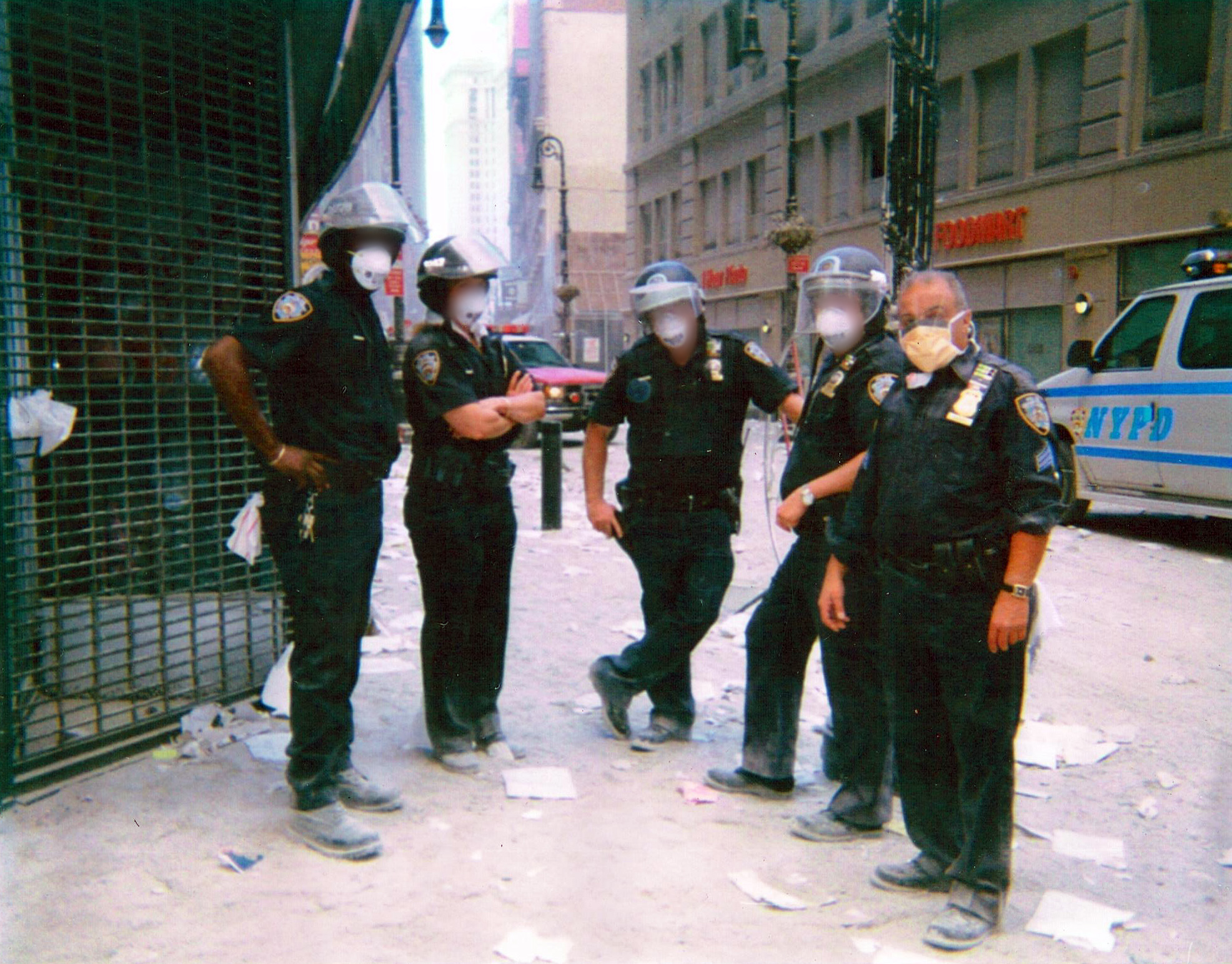 PHOTO: NYPD Sergeant Michael Guedes, far right, stands with a group of officers wearing face masks in Manhattan after the September 11 attack in 2001.