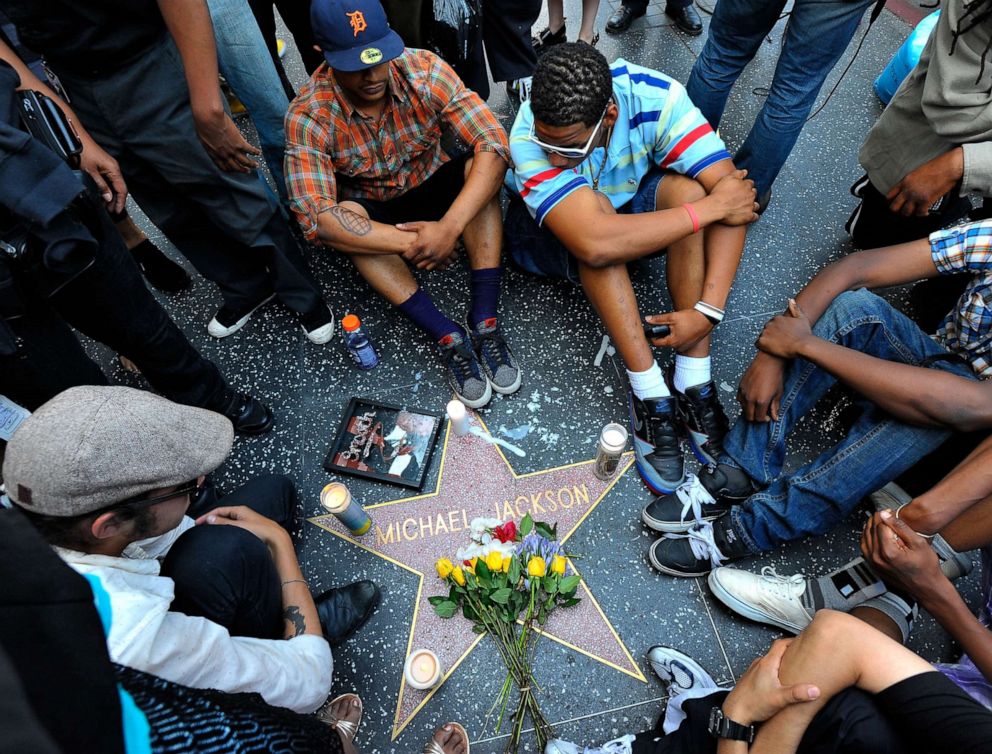 PHOTO: Fans of pop star Michael Jackson sit vigil at talk radio host Michael Jackson's Star on the Hollywood Walk of Fame mourning his death on June 25, 2009 in Los Angeles, California.