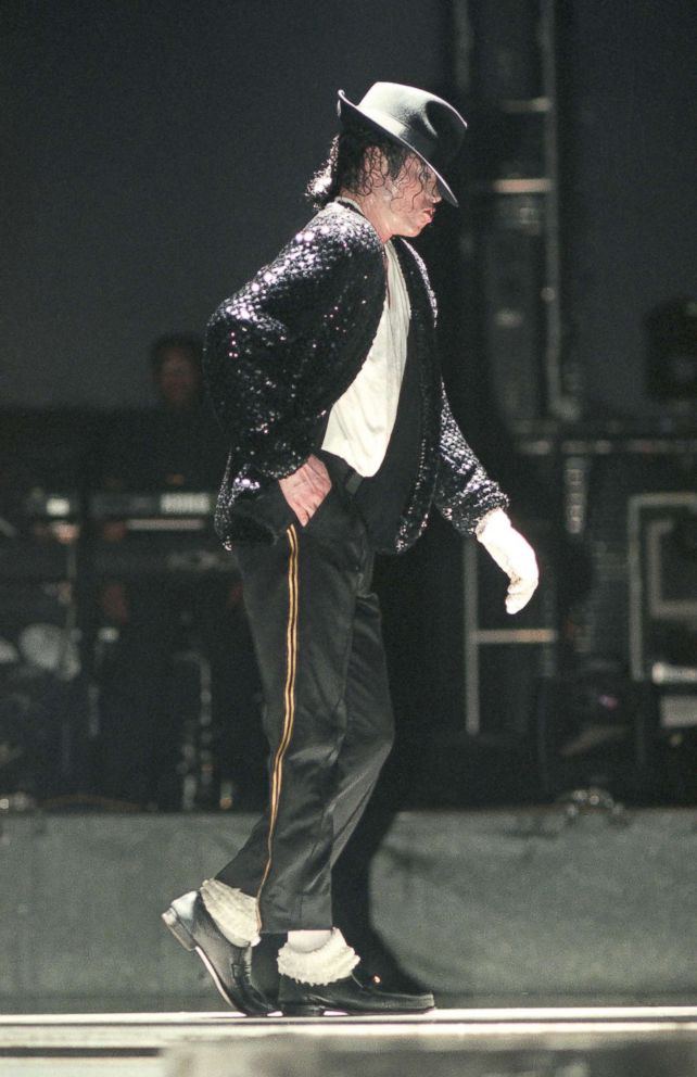 PHOTO: Michael Jackson moonwalks while performing on stage on his HIStory tour in Dec. 1996. 