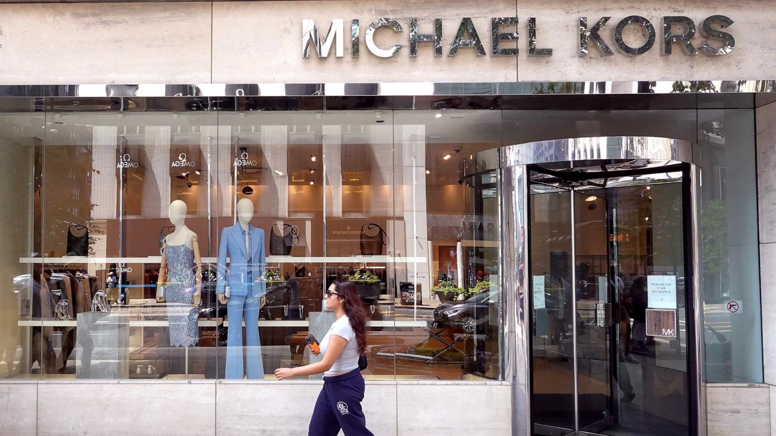 PHOTO: In this Aug. 10, 2023, file photo, a pedestrian walks past a Michael Kors store in Chicago.