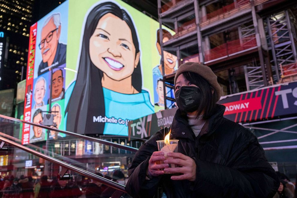 PHOTO: In this Jan. 18, 2022, file photo, a person holds a candle during a vigil in New York's Times Square, in honor of Michelle Alyssa Go, a victim of a subway attack several days earlier.