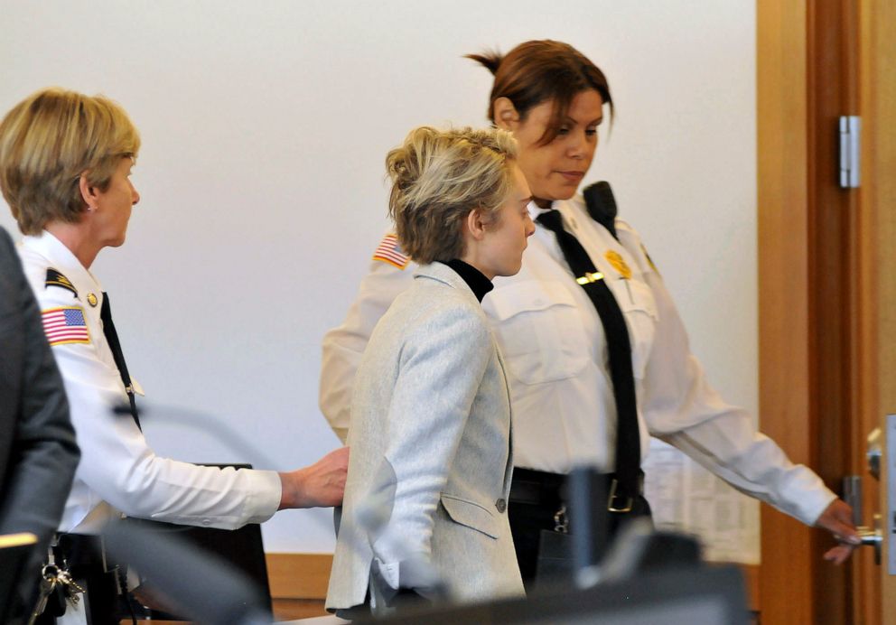 PHOTO: Michelle Carter, center, is led away by court officers after a hearing on her prison sentence in Taunton District Court in Taunton, Mass., Feb. 11, 2019.