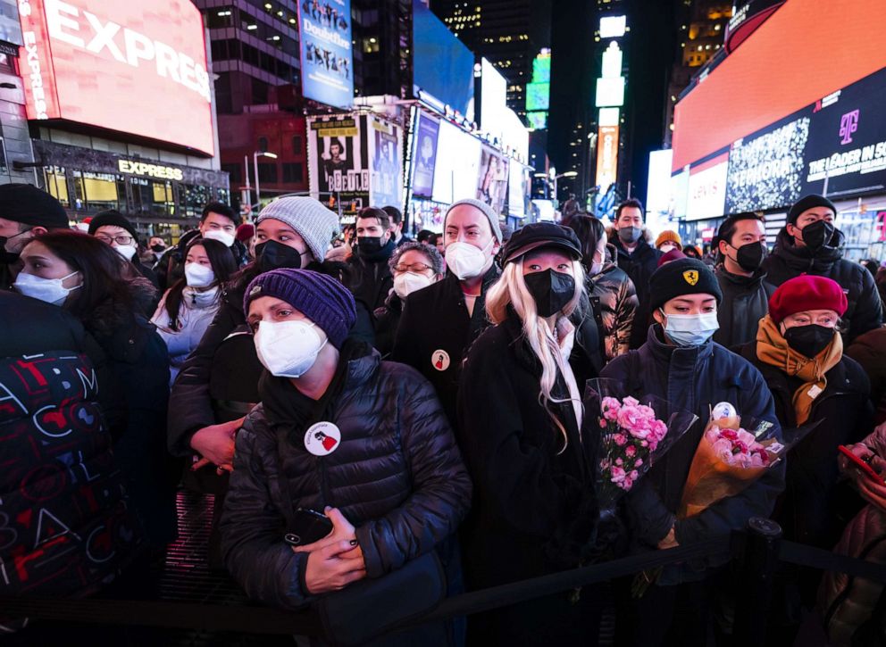 PHOTO: People gather for a vigil in honor of Michelle Alyssa Go, who was pushed in front of a subway car and killed on on Jan. 15, in Times Square in New York, Jan. 18, 2022.