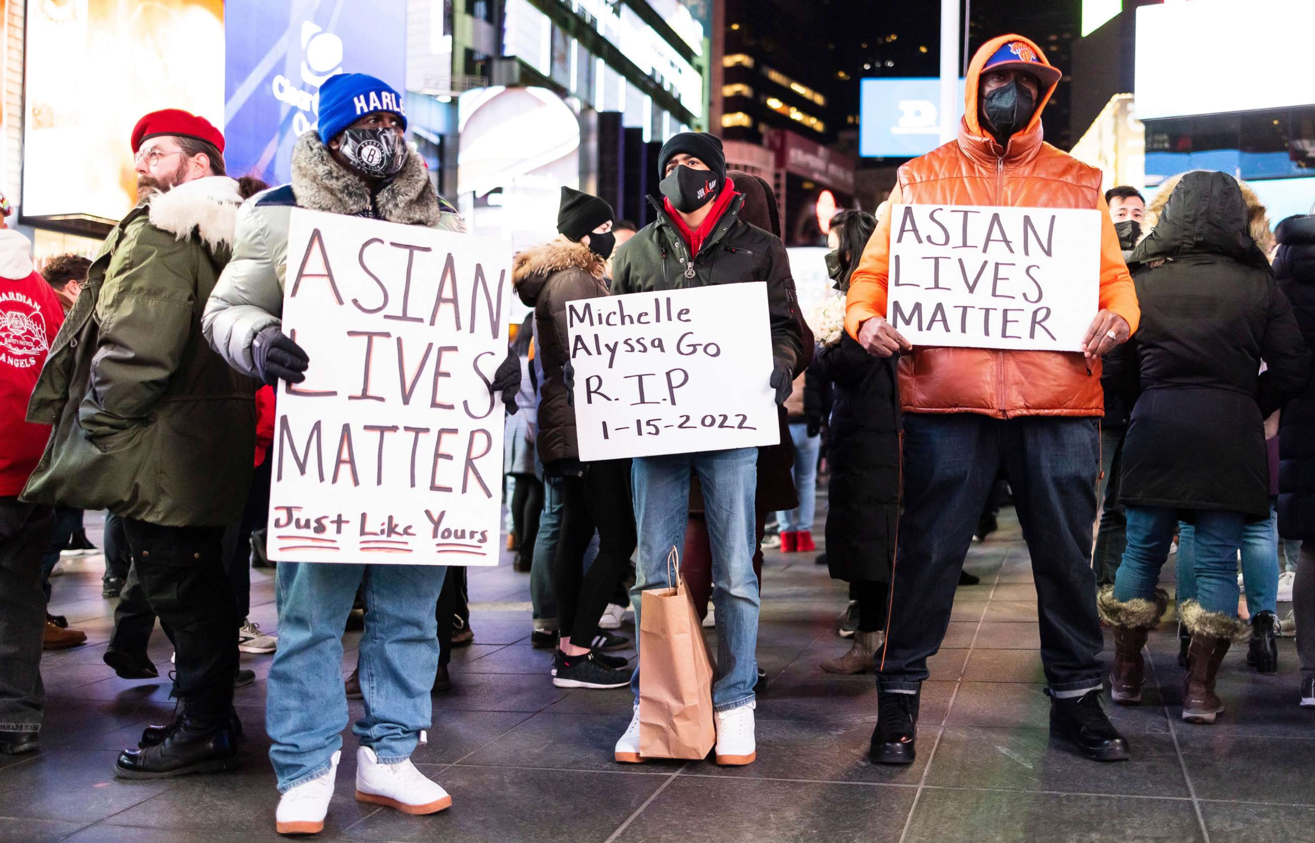 PHOTO: People gather for a vigil in honor of Michelle Alyssa Go, who was pushed in front of a subway car and killed on on Jan. 15, in Times Square in New York, Jan. 18, 2022.