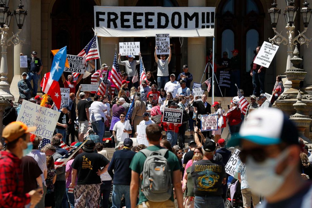 PHOTO: People protest at the State Capitol during a rally in Lansing, Mich., Wednesday, May 20, 2020.