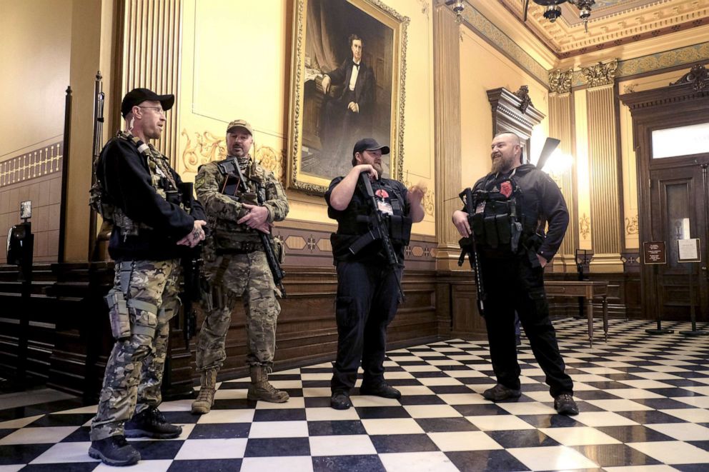 PHOTO: Armed protesters gather at the Michigan Capitol Building in Lansing, Mich., April 30, 2020. 