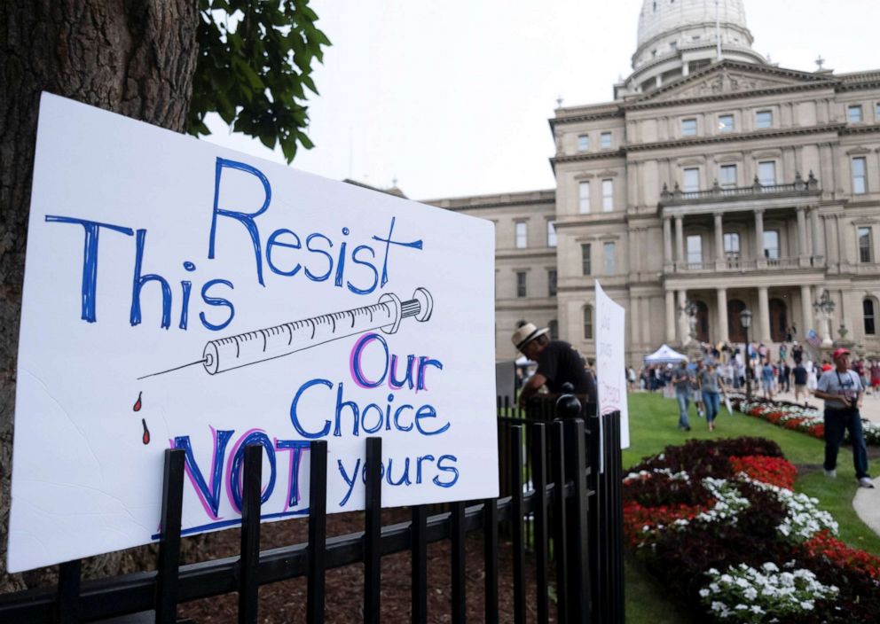 PHOTO: A sign is seen at a protest against the coronavirus disease (COVID-19) vaccine mandates being implemented by various hospitals, universities and business across the state of Michigan at the State Capitol building in Lansing, Michigan, Aug. 6, 2021.