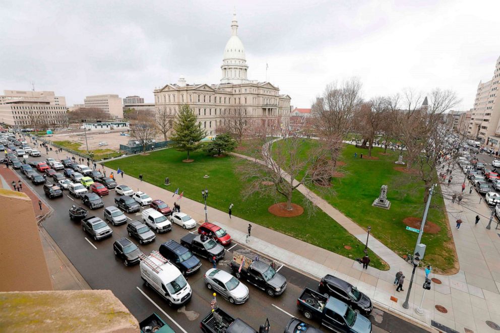 PHOTO: People in their vehicles protest against what they call excessive quarantine orders from Michigan Governor Gretchen Whitmer around the Michigan State Capitol in Lansing, Mich., April 15, 2020.