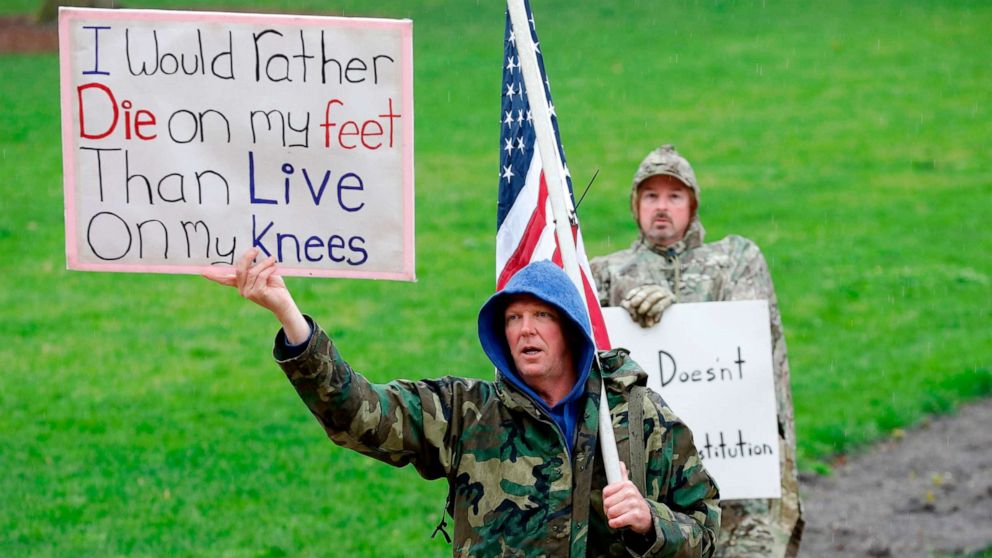 PHOTO: Demonstrators take part in an "American Patriot Rally," organized on April 30, 2020, by Michigan United for Liberty on the steps of the Michigan State Capitol in Lansing, demanding the reopening of businesses.