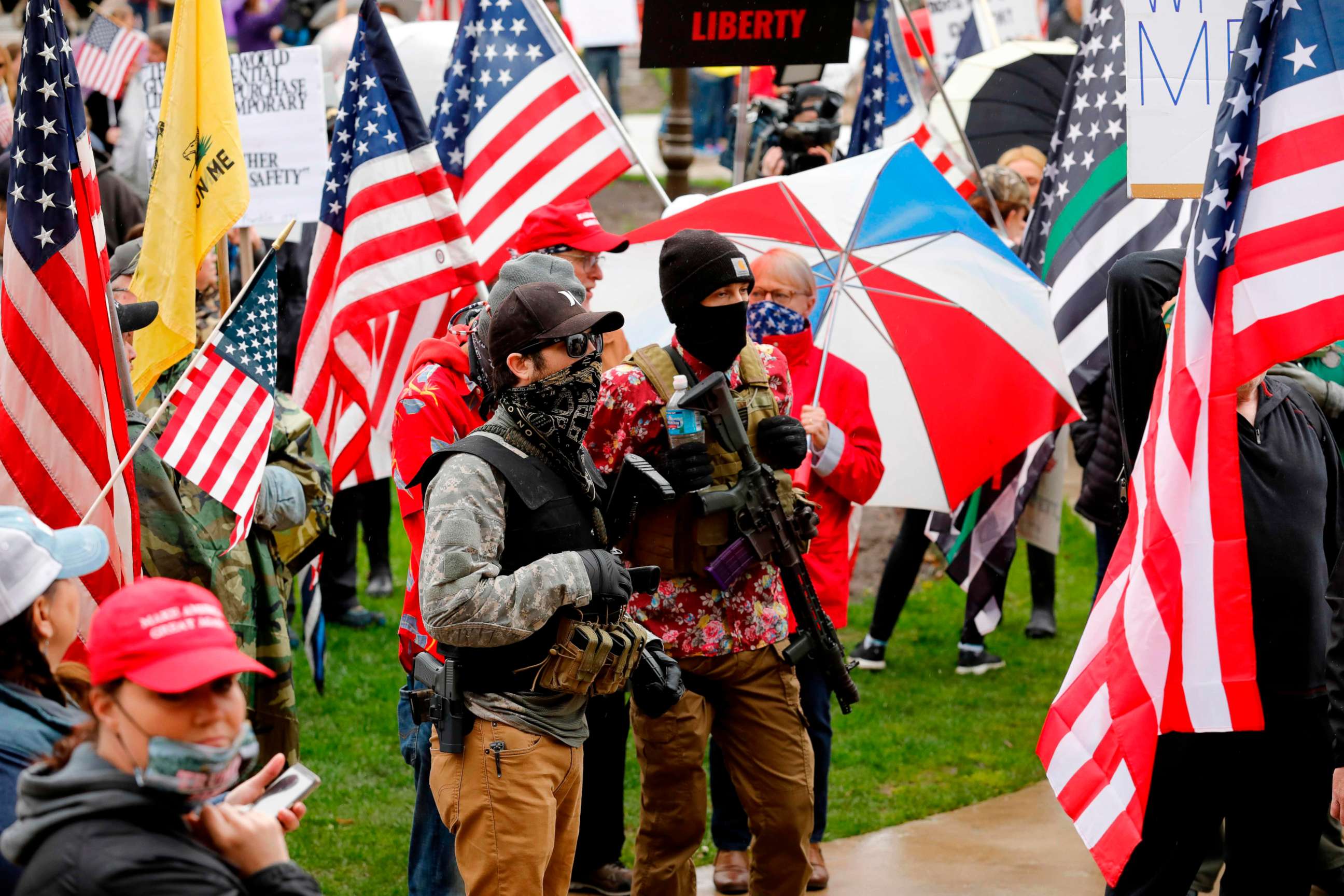 PHOTO: Armed protesters provide security as demonstrators take part in an "American Patriot Rally," organized on April 30, 2020, by Michigan United for Liberty on the steps of the Michigan State Capitol in Lansing, demanding the reopening of businesses.
