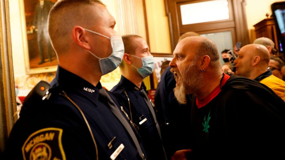 PHOTO: Protesters try to enter the Michigan House of Representative chamber after the American Patriot Rally for the reopening of businesses on the steps of the Michigan State Capitol in Lansing, Mich., April 30, 2020.