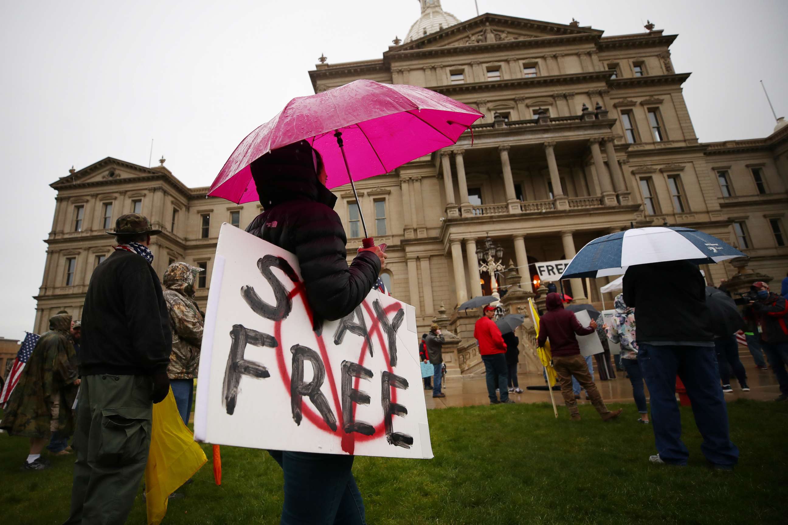 PHOTO: Protesters angry at Michigan Governor Gretchen Whitmer gather at the Michigan Capitol Building on May 14, 2020 in Lansing, Mich.