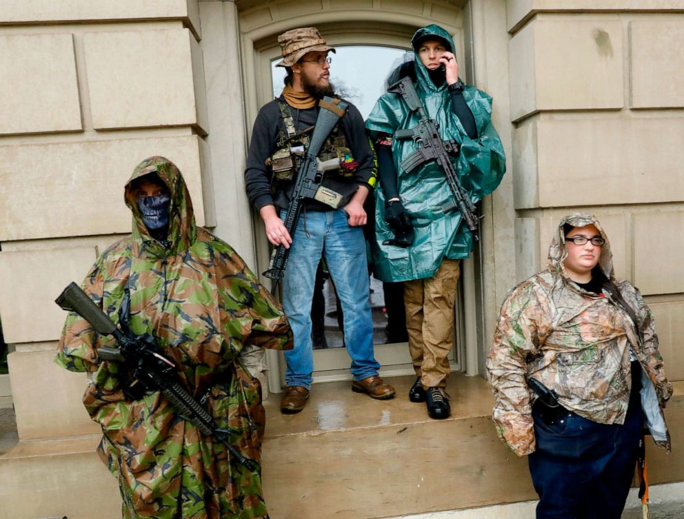 PHOTO: Armed demonstrators protest in Lansing, Mich., during a rally organized by Michigan United for Liberty on May 14, 2020, to protest the coronavirus pandemic stay-at-home orders.
