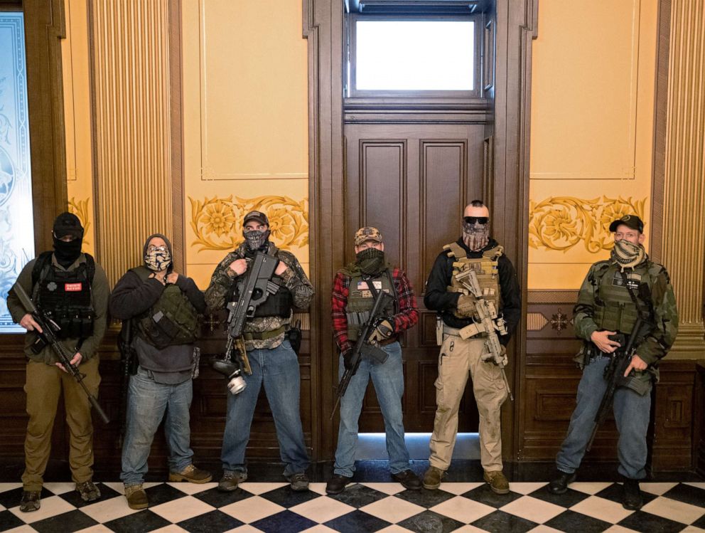 PHOTO: A militia group from Michigan, including Pete Musico, stands in front of the Governors office after protesters occupied the state capitol in Lansing, Mich., April 30, 2020.