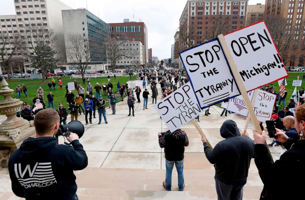 PHOTO: People protest against the coronavirus quarantine orders at the Michigan State Capitol in Lansing, Mich., April 15, 2020. 