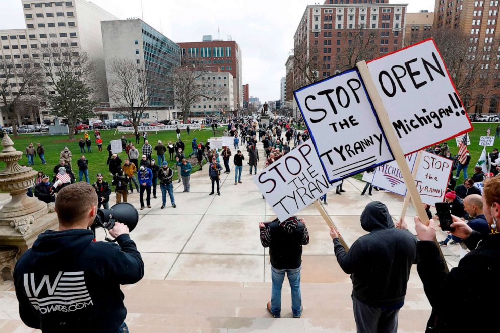 PHOTO: People protest against the coronavirus quarantine orders at the Michigan State Capitol in Lansing, Mich., April 15, 2020. 