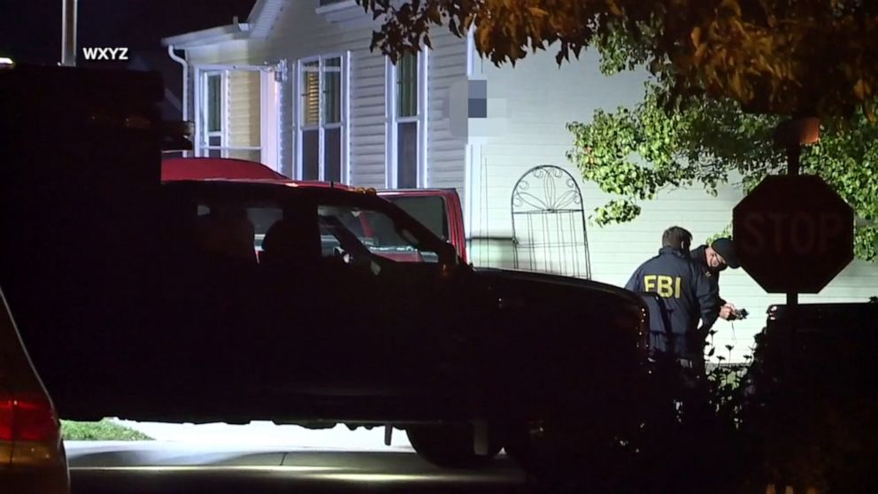 PHOTO: Federal and state officials execute a search warrant on a home in Hartland, Mich., late on Oct. 7, 2020.