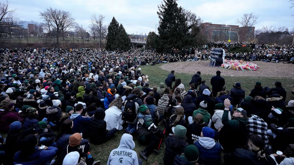 PHOTO: Mourners sit at The Rock on the grounds of Michigan State University in East Lansing, Mich., on Feb. 15, 2023.