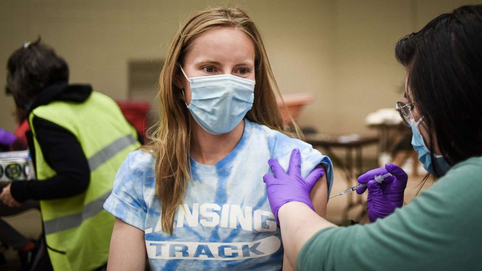 PHOTO: Second-year Michigan State University graduate student Genevieve Gottardo gets her Pfizer COVID-19 vaccination shot on April 14, 2021, at the student vaccination clinic at the MSU Pavilion in East Lansing, Mich.