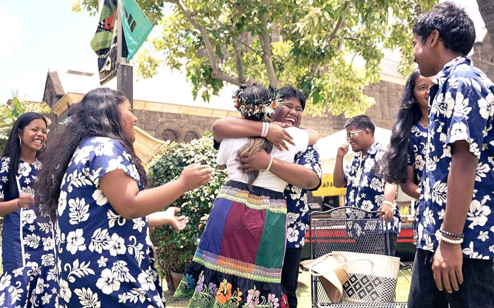 PHOTO: Marshallese students from Waipahu High School embrace Shanty Asher at Celebrate Micronesia Festival in Oahu.