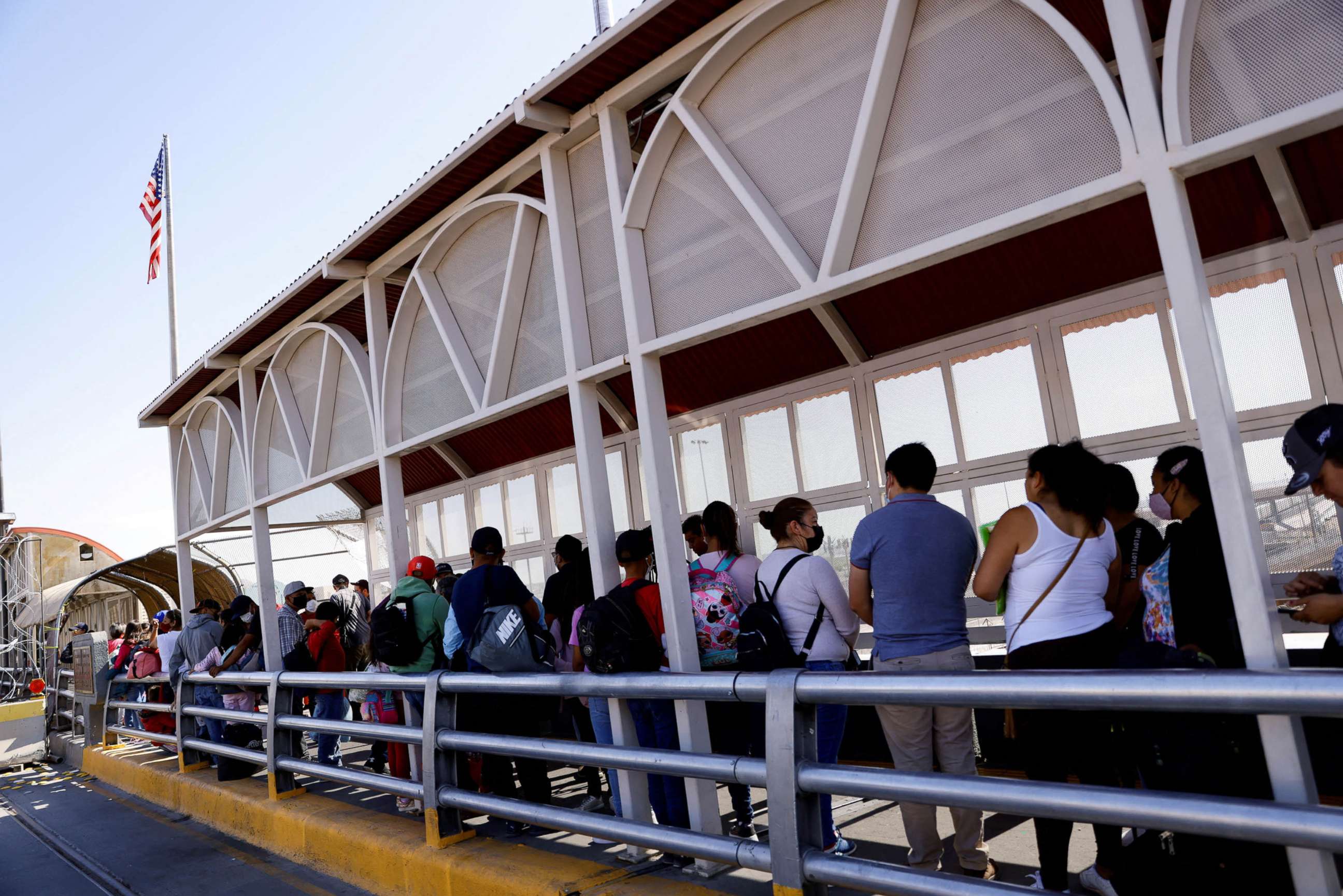PHOTO: Asylum-seeking migrants wait at the Paso del Norte International Bridge to request information about their asylum in the United States in Ciudad Juarez, Mexico, May 23, 2022.