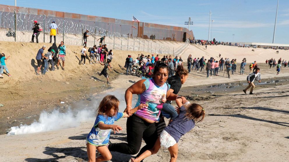 PHOTO: Maria Meza runs away from tear gas with her five-year-old twin daughters Saira Mejia Meza, left, and Cheili Mejia Meza in front of the border wall between the U.S. and Mexico, in Tijuana, Nov. 25, 2018.