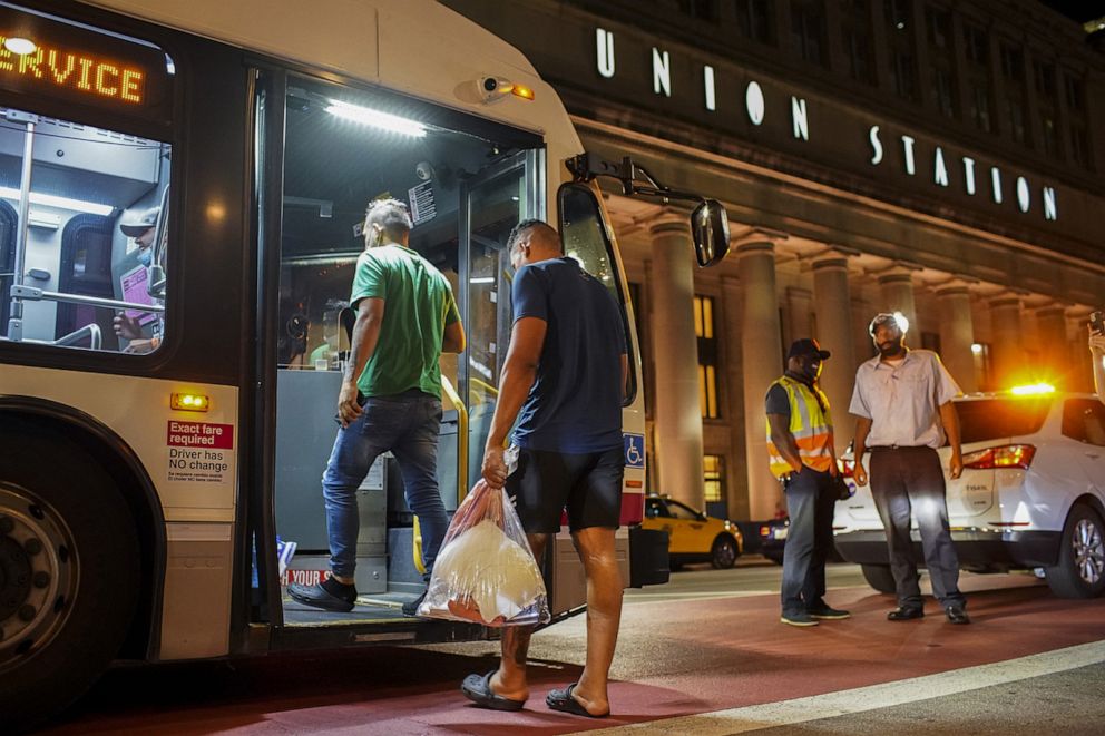 PHOTO: A group of migrants board a CTA bus at Union Station in Chicago, to be taken to a Salvation Army shelter after arriving from Texas on Aug. 31, 2022.