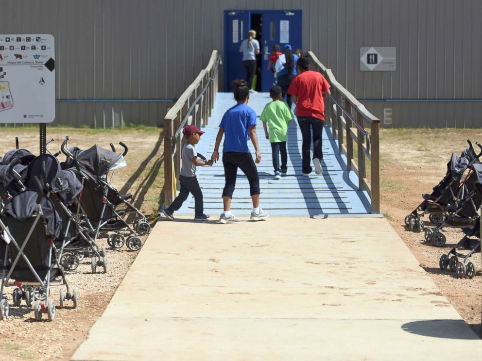 PHOTO: Immigrants walk into a building at South Texas Family Residential Center in Dilley, Texas, Aug. 9, 2018.