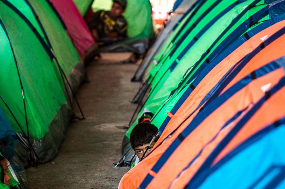 PHOTO: A Mexican migrant boy emerges next to tents at a shelter in Tijuana, Baja California state, Mexico, in the border with the U.S., Oct. 22, 2018.