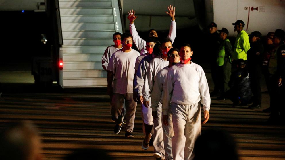 PHOTO: Venezuelan migrants flown from Guantanamo Bay via Honduras, walk after arriving on a deportation flight at Simon Bolivar International Airport in Maiquetia, La Guaira State, Venezuela, Feb. 20, 2025.