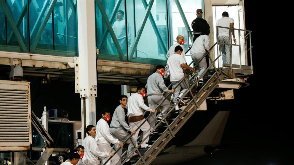 PHOTO: Venezuelan migrants flown from Guantanamo Bay via Honduras, walk after arriving on a deportation flight at Simon Bolivar International Airport in Maiquetia, La Guaira State, Venezuela, Feb. 20, 2025.
