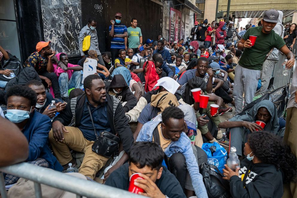 PHOTO: Dozens of recently arrived migrants to New York City camp outside of the Roosevelt Hotel, which has been made into a reception center, as they try to secure temporary housing on Aug. 01, 2023 in New York City.