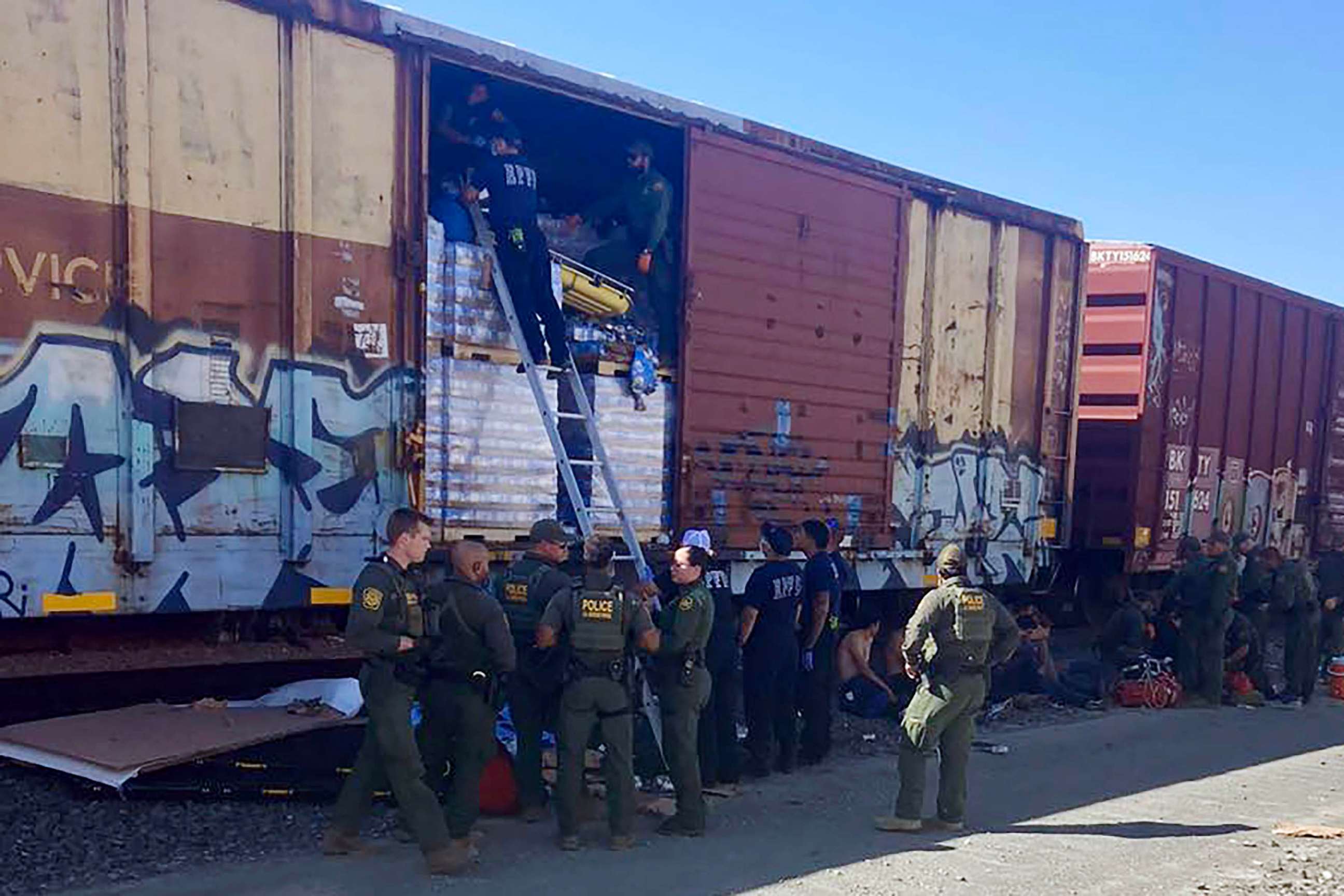 PHOTO: Photo shows officers responding to the scene where one migrant died and three others were hospitalized on Saturday after they and eight others were rescued from a Union Pacific train box car in Eagle Pass, Texas.