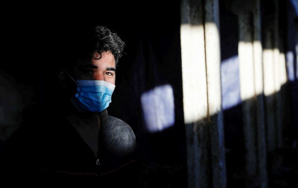 PHOTO:A migrant from Syria stands inside an abandoned house close to the border with Hungary and Romania in the village of Majdan, Serbia, Feb. 3, 2022.