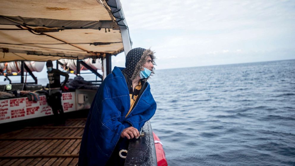 PHOTO: A man from Syria looks out at sea after being rescued in a wooden boat with 27 refugees from Africa and Magreb by Open Arms NGO 45 nautical miles far away from the Libyan coast in the Mediterranean Sea, March 5, 2022.