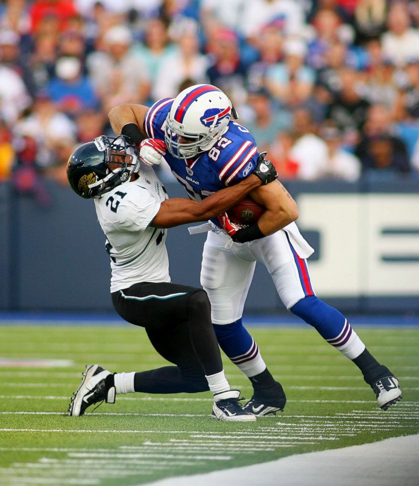 PHOTO: Mike Caussin #82 of the Buffalo Bills is tackled by Derek Cox #21 of the Jacksonville Jaguars at Ralph Wilson Stadium, Aug. 27, 2011, in Orchard Park, New York.