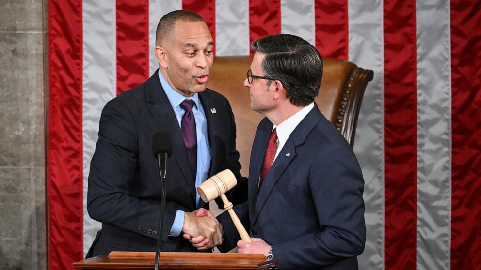 PHOTO: House Minority Leader Hakeem Jeffries shakes hands with Speaker of the House Mike Johnson after presenting him with the gavel during the first day of the 119th Congress in the House Chamber at the Capitol in Washington, Jan. 3, 2025. 