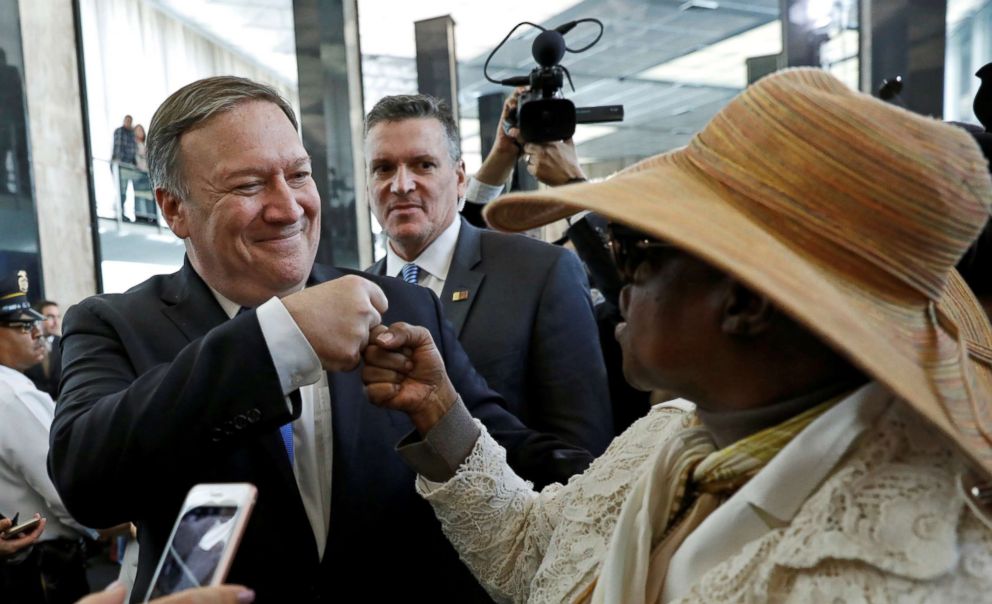 PHOTO: New United States Secretary of State Mike Pompeo fist bumps with a woman upon his arrival during his first day at the State Department in Washington, May 1, 2018.