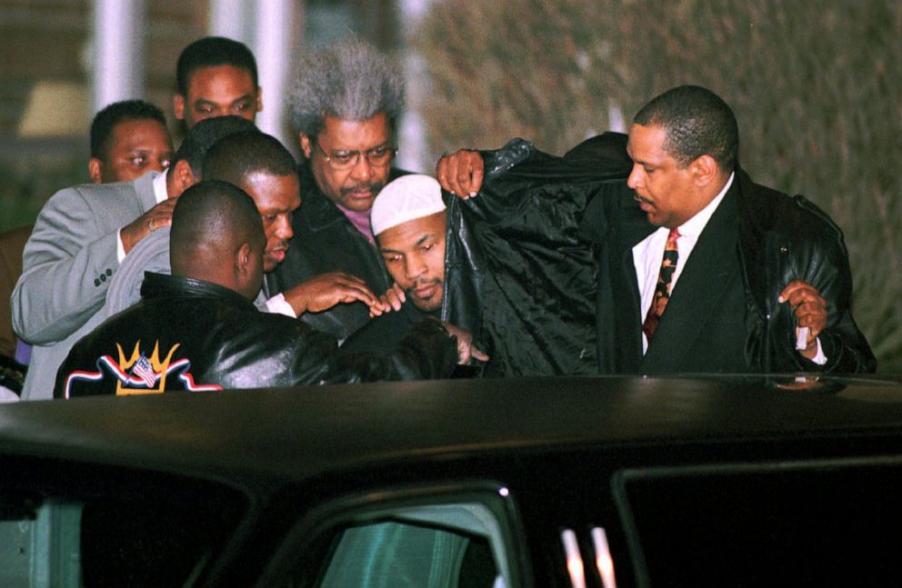 PHOTO: Boxer Mike Tyson makes his way from the Plainfield Youth Detention Center in Plainfield, Ind., on March 24, 1998, under the heavy cover of his body guards and and friends.