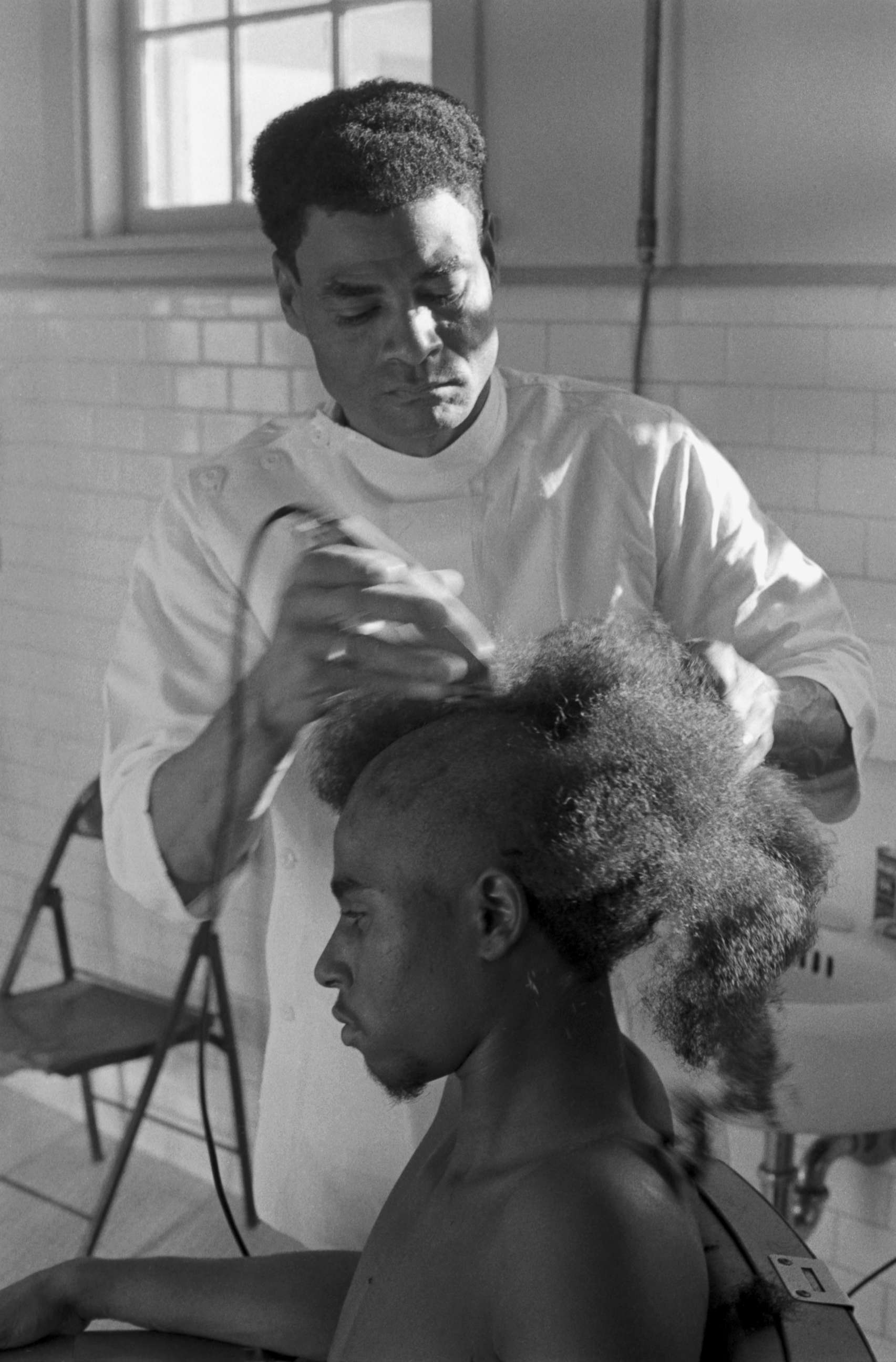 PHOTO: A Marine Corps recruit has his hair shorn during the early hours of his training at Parris Island, in South Carolina.