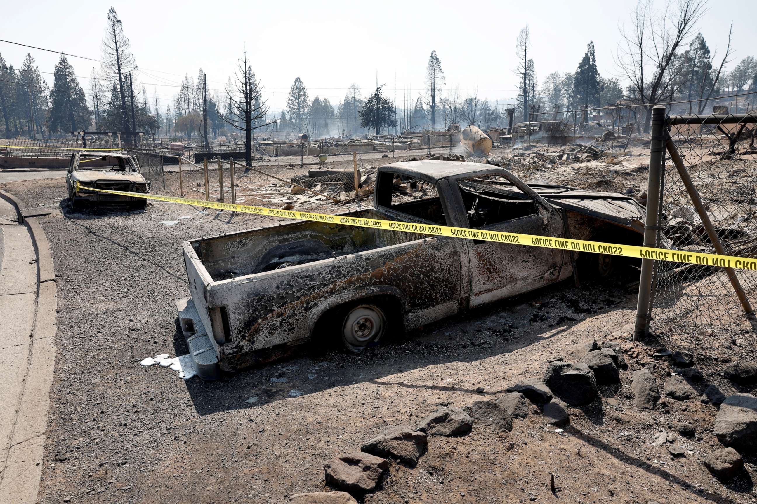 PHOTO: Crime scene tape barricades the area near burned cars in the aftermath of the Mill Fire in Weed, California, Sept. 3, 2022.