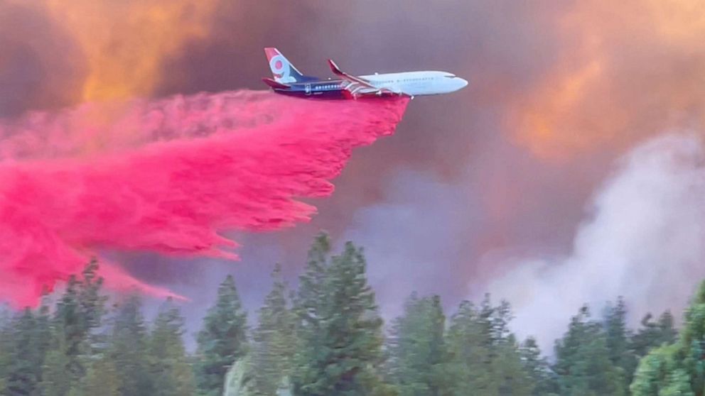 PHOTO: A plane drops fire retardant over the Mill Fire on the outskirts of Weed, Calif., Sept. 2, 2022, in this still image obtained from a video. 