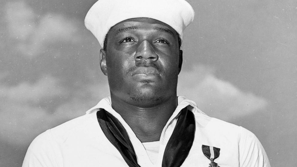 PHOTO: Mess Attendant 2nd Class Doris Miller stands at attention after being awarded the Navy Cross medal for for his actions aboard the battleship USS West Virginia (BB-48) during the Dec. 7, 1941 Japanese attack on Pearl Harbor. 