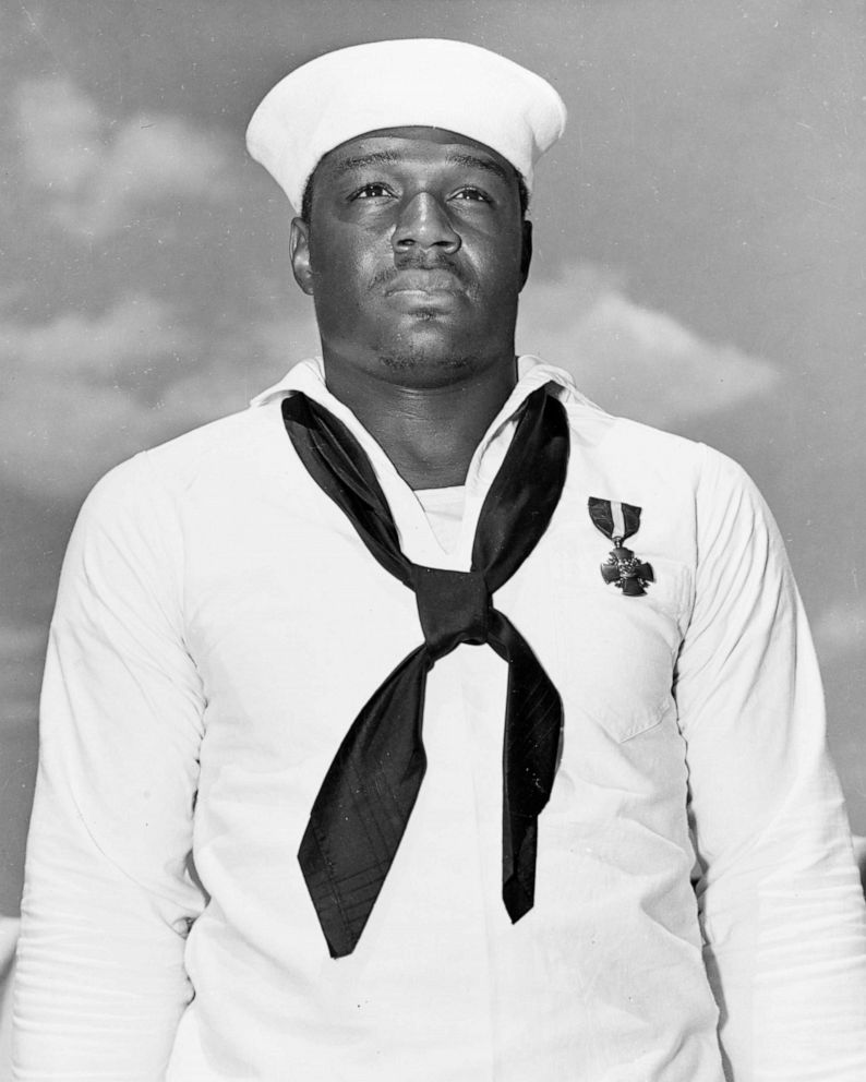 PHOTO: Mess Attendant 2nd Class Doris Miller stands at attention after being awarded the Navy Cross medal for for his actions aboard the battleship USS West Virginia (BB-48) during the Dec. 7, 1941 Japanese attack on Pearl Harbor. 