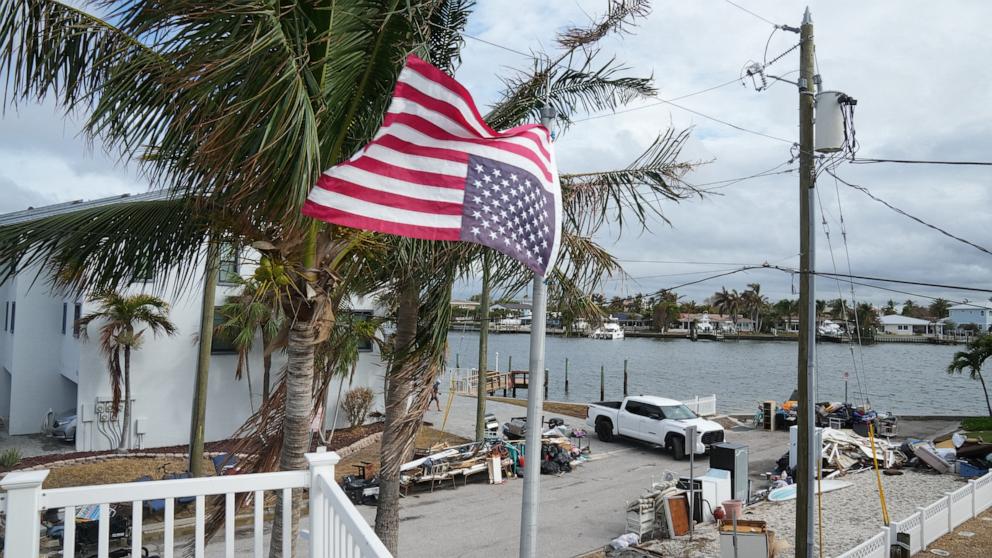 PHOTO: An American flag fly's upside down, the international sign for distress, at a home ahead of Hurricane Milton's expected landfall in the middle of this week in Treasure Island, Fla., Oct. 7, 2024. 