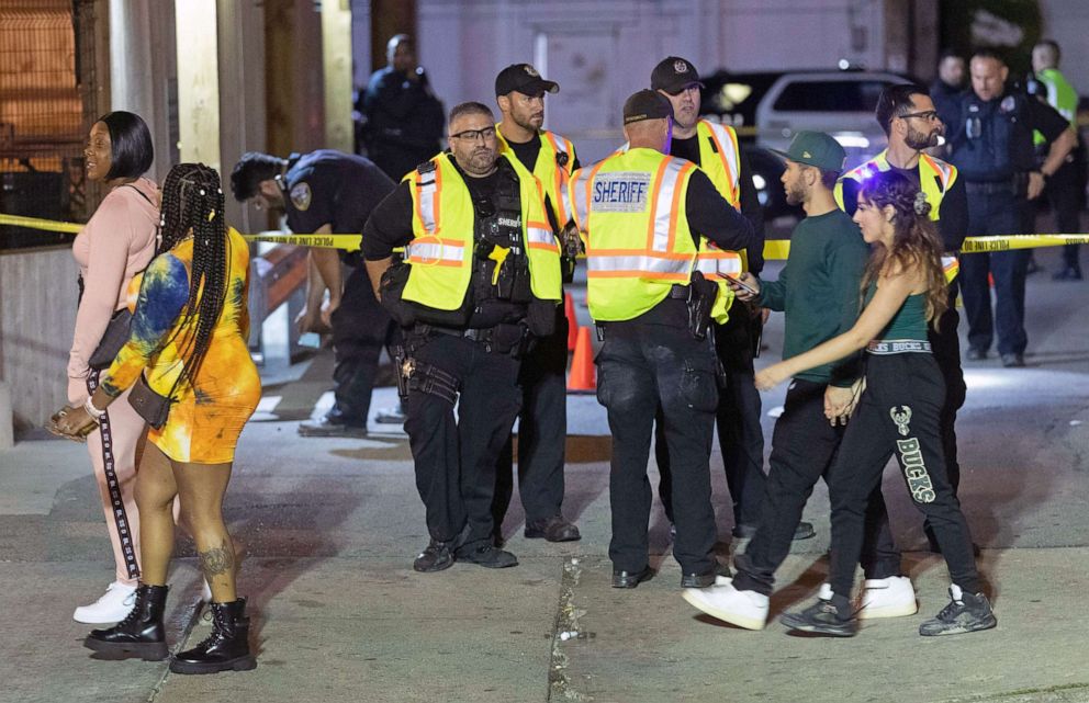 PHOTO: Milwaukee County Sheriff's deputies and Milwaukee Police officers work at a shooting scene at Elwood's Liquor which occurred after the NBA Finals game at Fiserv Forum between the Milwaukee Bucks and the Phoenix Suns on July 21, 2021, in Milwaukee.