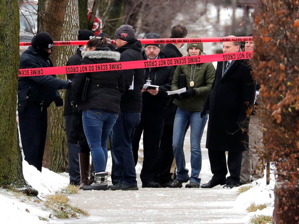 PHOTO: Milwaukee Police inspectors gather in front of a home near 12th and Dakota that was taped off as a crime scene, Feb. 6, 2019, after a Milwaukee Police officer was shot Wednesday morning on the city's south side.