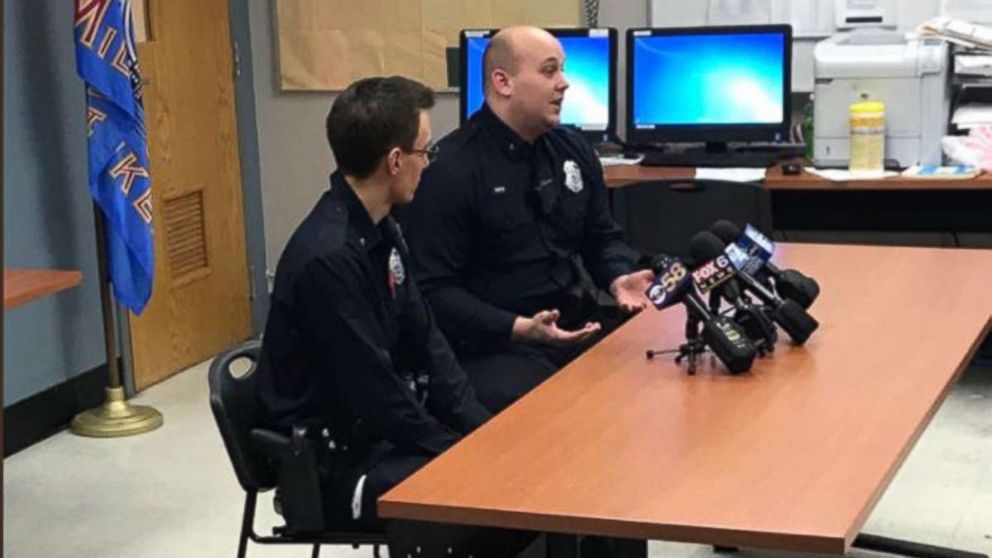 PHOTO: Milwaukee Police Dept. officers Nicholas Schlei and Nicholas Reid talking to local media about their heroics last night when they saved teenagers from a burning car. 