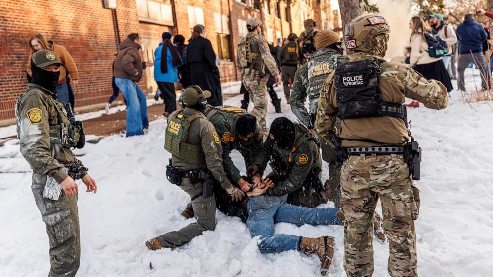 PHOTO: US Border Patrol agents detain a person near Roosevelt High School during dismissal time in Minneapolis, Minnesota, January 7, 2026. 