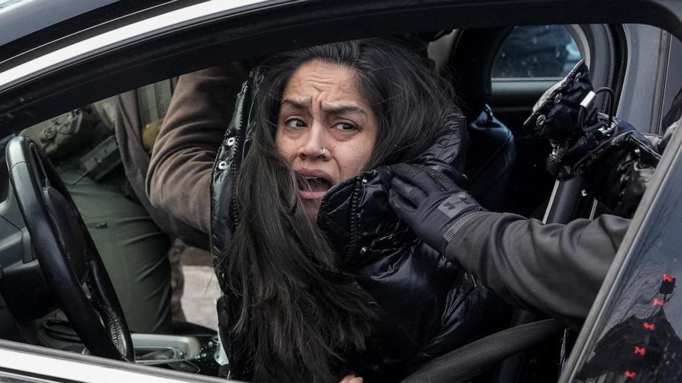 PHOTO: Federal agents detain a woman as they pull her from her car days after an ICE agent fatally shot Renee Nicole Good, in Minneapolis, Minnesota, January 13, 2026.